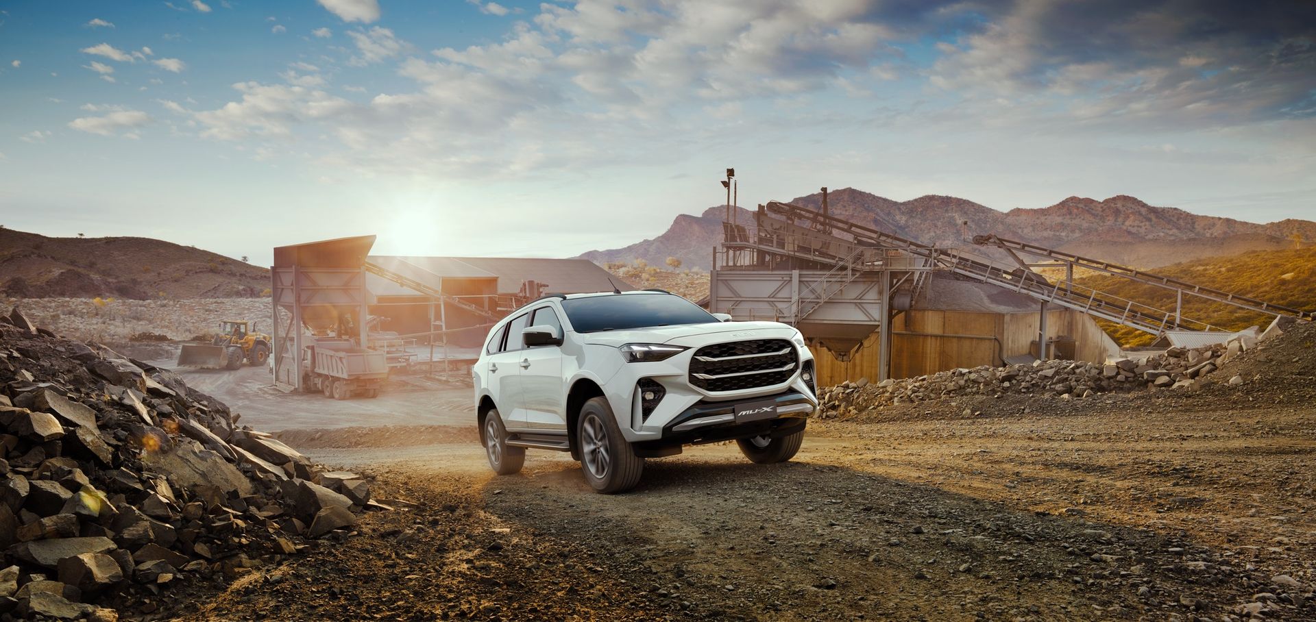 A certified pre-owned Isuzu D-MAX at a quarry at sunrise