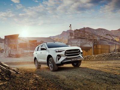 A certified pre-owned Isuzu D-MAX at a quarry at sunrise